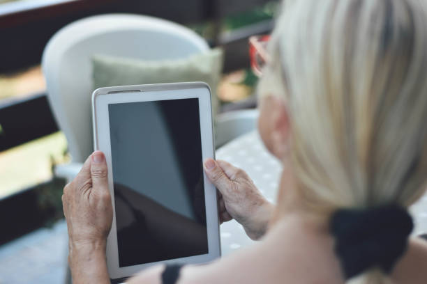 istock Mature woman using tablet and smarthphone 1169584992