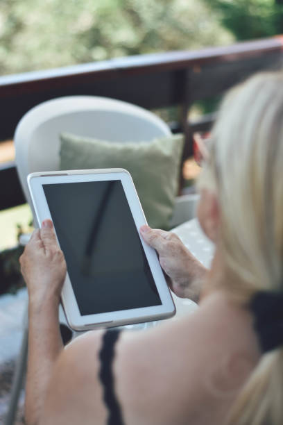 istock Mature woman using tablet and smarthphone 1169585057
