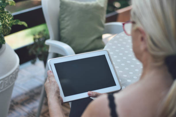 istock Mature woman using tablet and smarthphone 1169585403