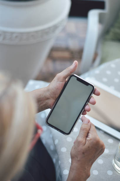 istock Mature woman using tablet and smarthphone 1169585845