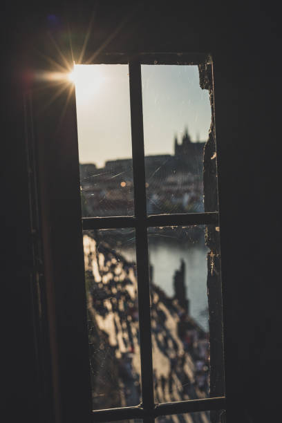istock Old dirty window with spider web on Old Town Bridge Tower with blurred Charles Bridge in background. Prague, Czech Republic. 1169591009