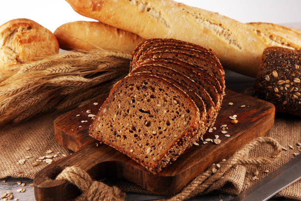 istock freshly baked bread on wooden board. cutted organic bread 1169594563