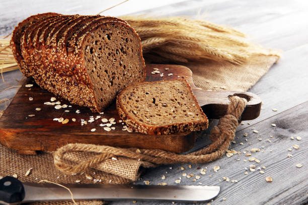 istock freshly baked bread on wooden board. cutted organic bread 1169595253