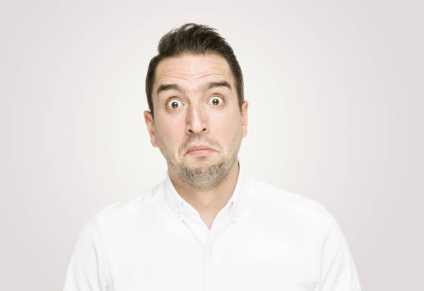 istock Mid adult man looking at camera with a shock expression 1169596609