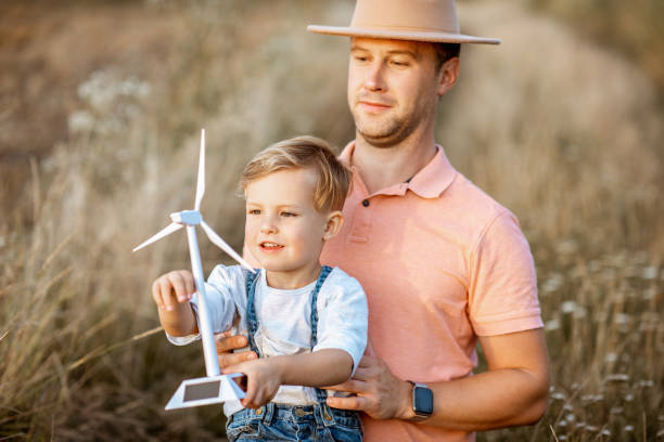 istock Father and young son playing with wind turbine 1169598231