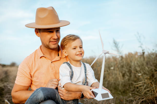 istock Father and young son playing with wind turbine 1169598314