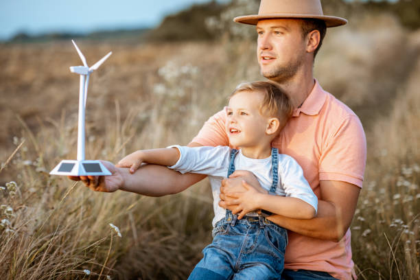 istock Father and young son playing with wind turbine 1169598315