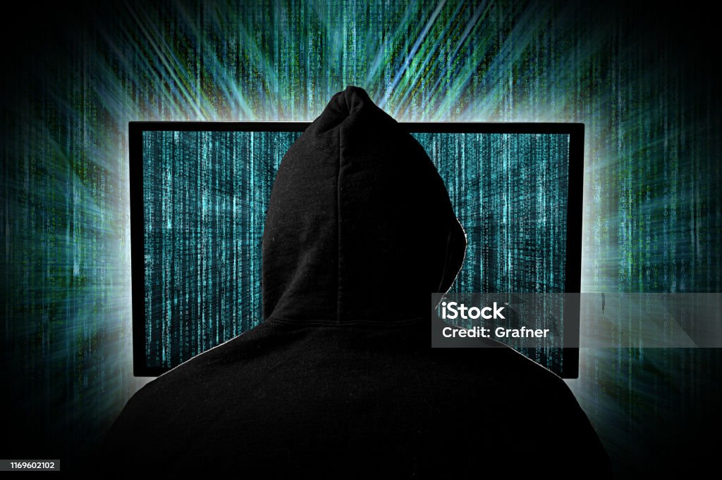 Hacking Images Hacker Behind Glowing Computer Monitor Display In Front Of Green Source ...