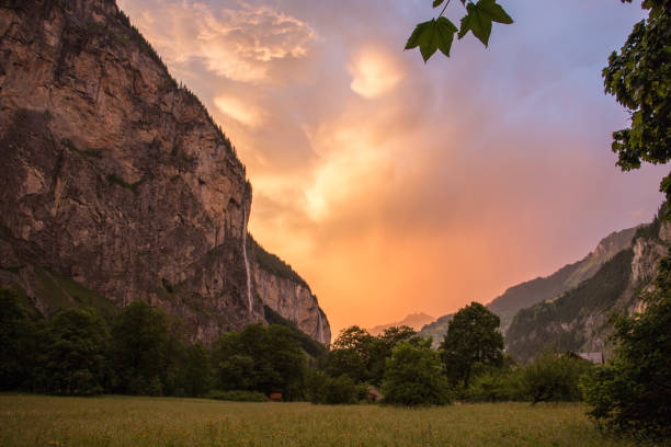 sunrise after a rainstorm of lauterbrunnen waterfall and valley - jungfrau waterfall tree nature imagens e fotografias de stock