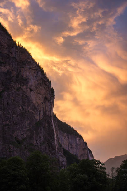 sunrise after a rainstorm of lauterbrunnen waterfall and valley - jungfrau waterfall tree nature imagens e fotografias de stock