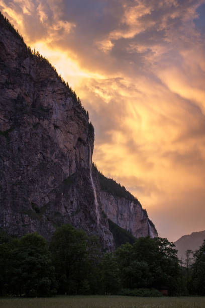 sunrise after a rainstorm of lauterbrunnen waterfall and valley - jungfrau waterfall tree nature imagens e fotografias de stock