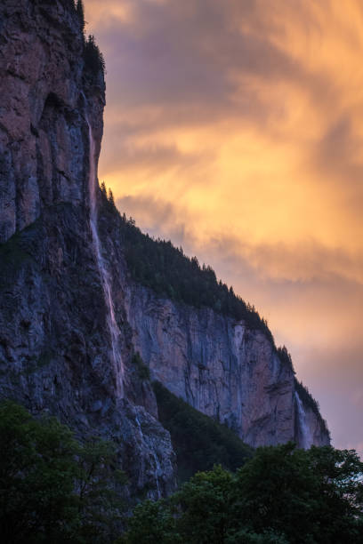 sunrise after a rainstorm of lauterbrunnen waterfall and valley - jungfrau waterfall tree nature imagens e fotografias de stock