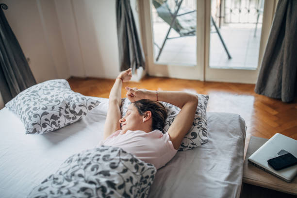 istock Sleepy woman stretching 1169610185