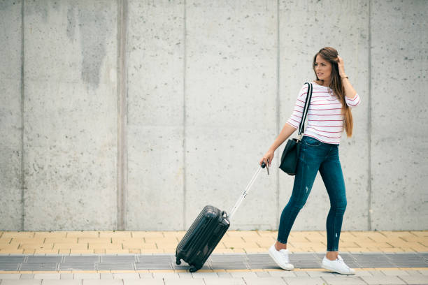 istock Woman carrying luggage. 1169610498