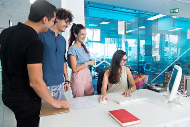 istock Young people smiling and surprised watching a computer in a coworking office. 1169613856