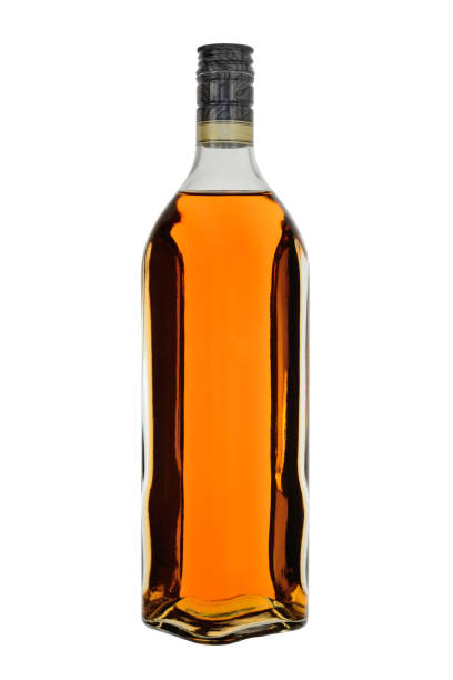 glass bottle of whisky or brandy, extended shape, isolated on a white background - hard liqueur imagens e fotografias de stock