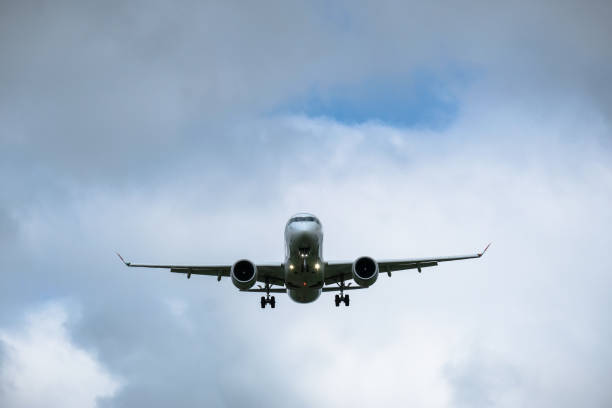 istock Airplane in landing approach with dark cloudscape 1169618249