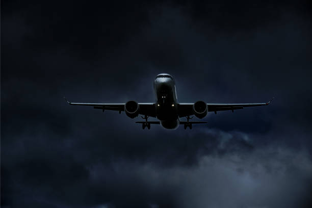 istock Airplane in landing approach with dark cloudscape 1169618257