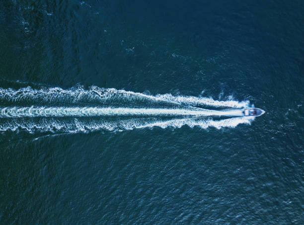 Power Boat Below Aerial view of a powerboat in open ocean. racing boat photos stock pictures, royalty-free photos & images