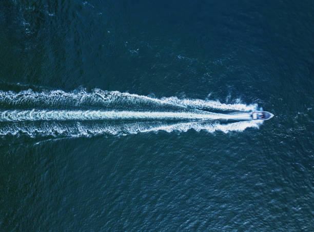 Power Boat Below Aerial view of a powerboat in open ocean. sea wake stock pictures, royalty-free photos & images
