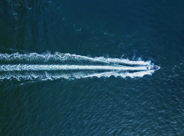 Aerial view of a powerboat in open ocean.