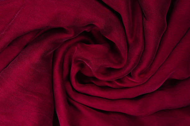 istock Soft smooth burgundy silk fabric background. Fabric texture. 1169619524