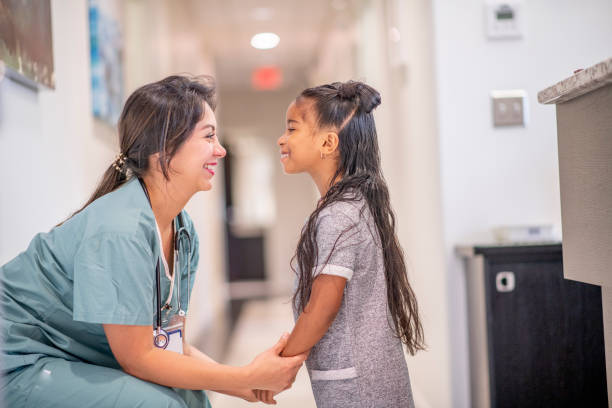 istock Little girl and caring nurse 1169620964