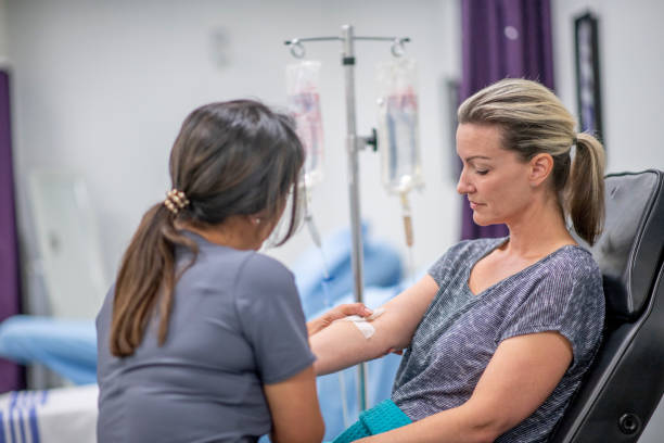 istock Women receives IV drip treatment 1169621485