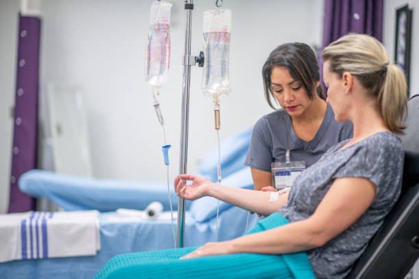 istock Women receives IV drip treatment 1169621492