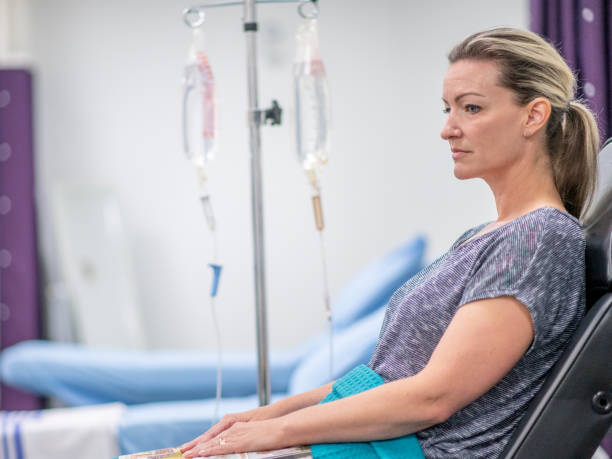 istock Women receives IV drip treatment 1169621498