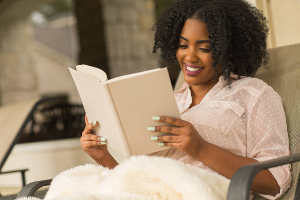 istock African American woman reading a book. 1169623334