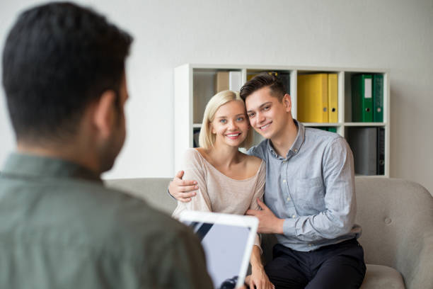 istock Young happy couple with psychologist 1169625500