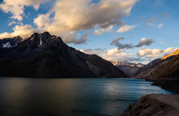 istock Snow capped mountain and blue lake 1169625682