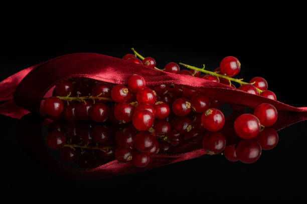 istock Fresh red currant isolated on black glass 1169626058