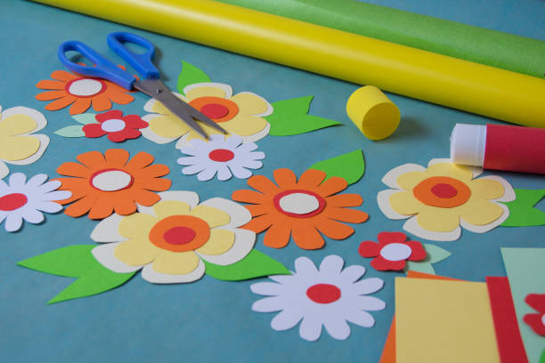 istock Flowers cut from color paper and card 1169627983
