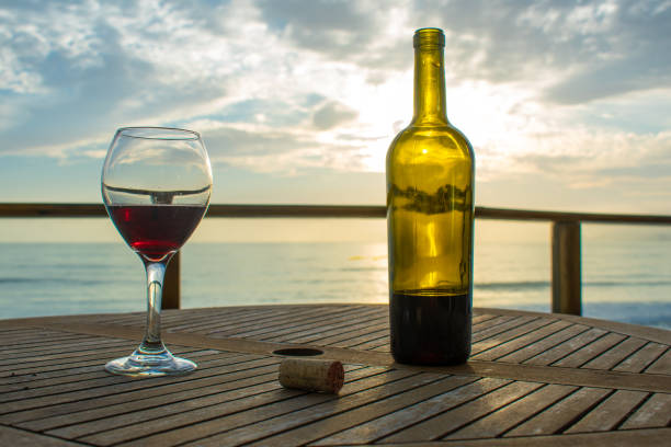 istock glass of wine and beach 1169628185