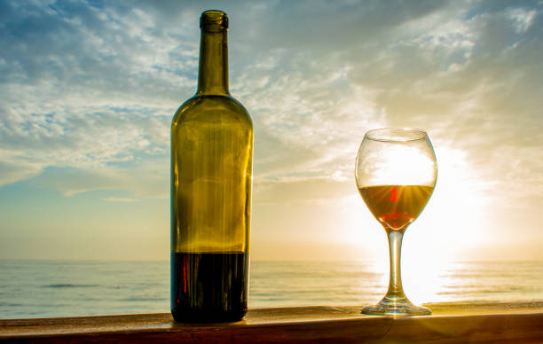 istock glass of wine and beach 1169628849