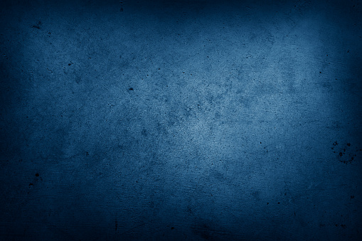 Closeup of blue textured background. Dark edges. Copy space