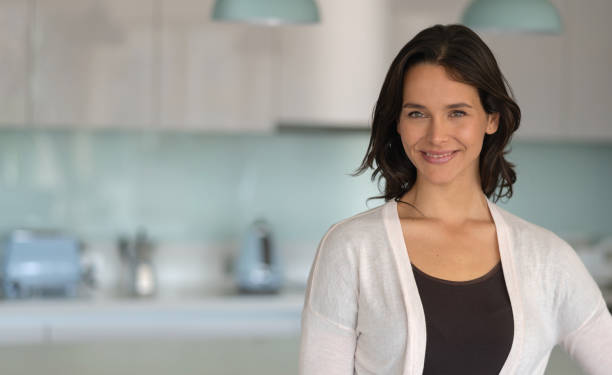 istock Confident beautiful woman at home facing camera smiling 1169630804