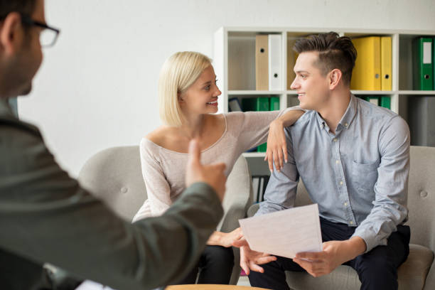 istock Happy couple talk with therapist 1169631978