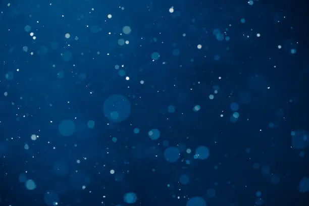 blue light background with snowflakes particles