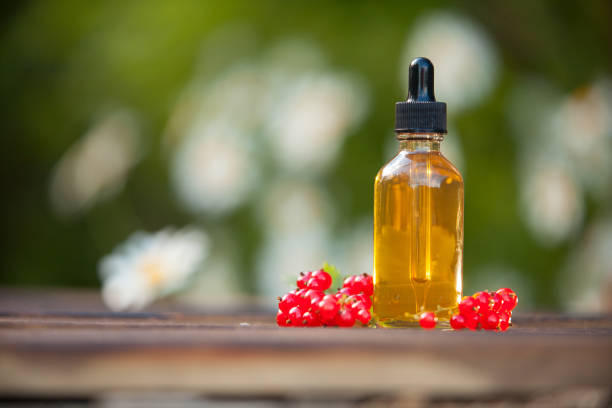 istock Essence of currant  on  table in beautiful glass Bottle 1169634522