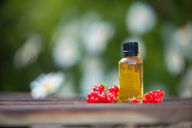 istock Essence of currant  on  table in beautiful glass Bottle 1169634528
