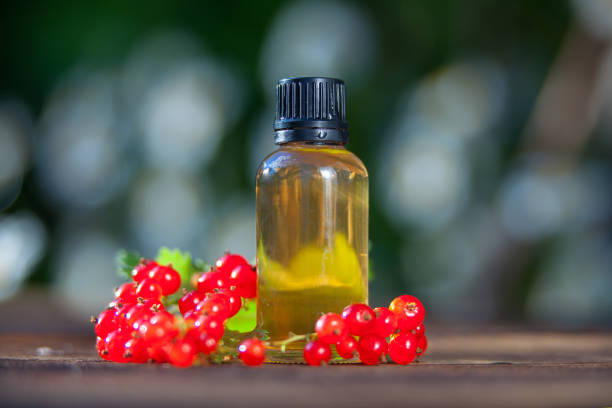 istock Essence of currant  on  table in beautiful glass Bottle 1169634607