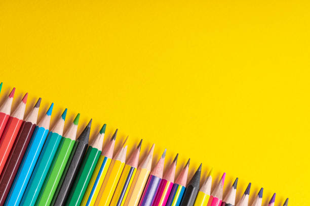 istock Many sharpened colored pencils laid out on a yellow background. Copyspace. 1169634723