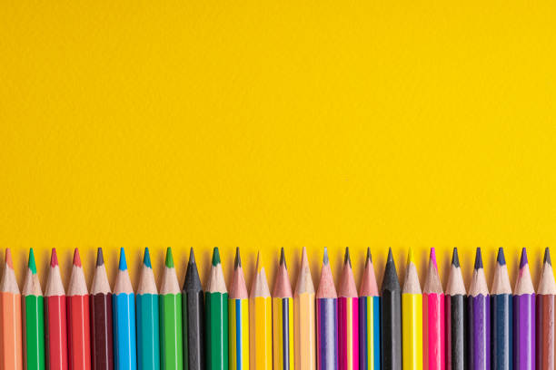 istock Many sharpened colored pencils laid out on a yellow background. Copyspace. 1169634754