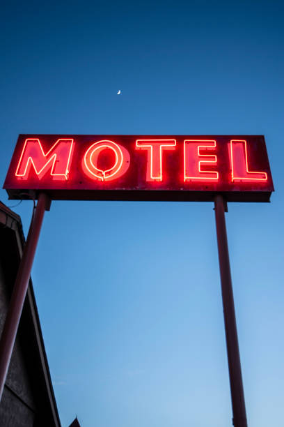istock illuminated neon motel sign red letters dark blue sky 1169637452