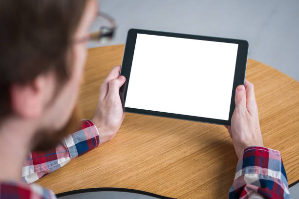 istock Man holding black digital tablet device with white blank screen - mockup image 1169638249
