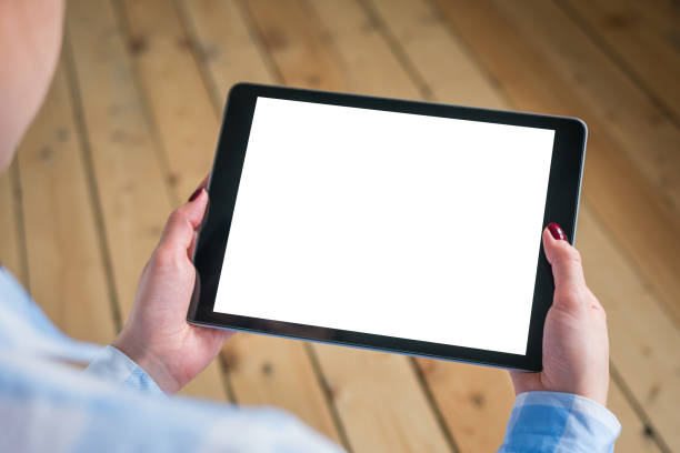 istock Woman holding black digital tablet device with white blank screen - mockup image 1169638254
