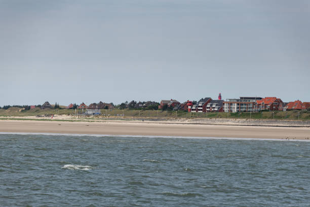 Amrum in Germany from ferry at a partly cloudy day in Summer